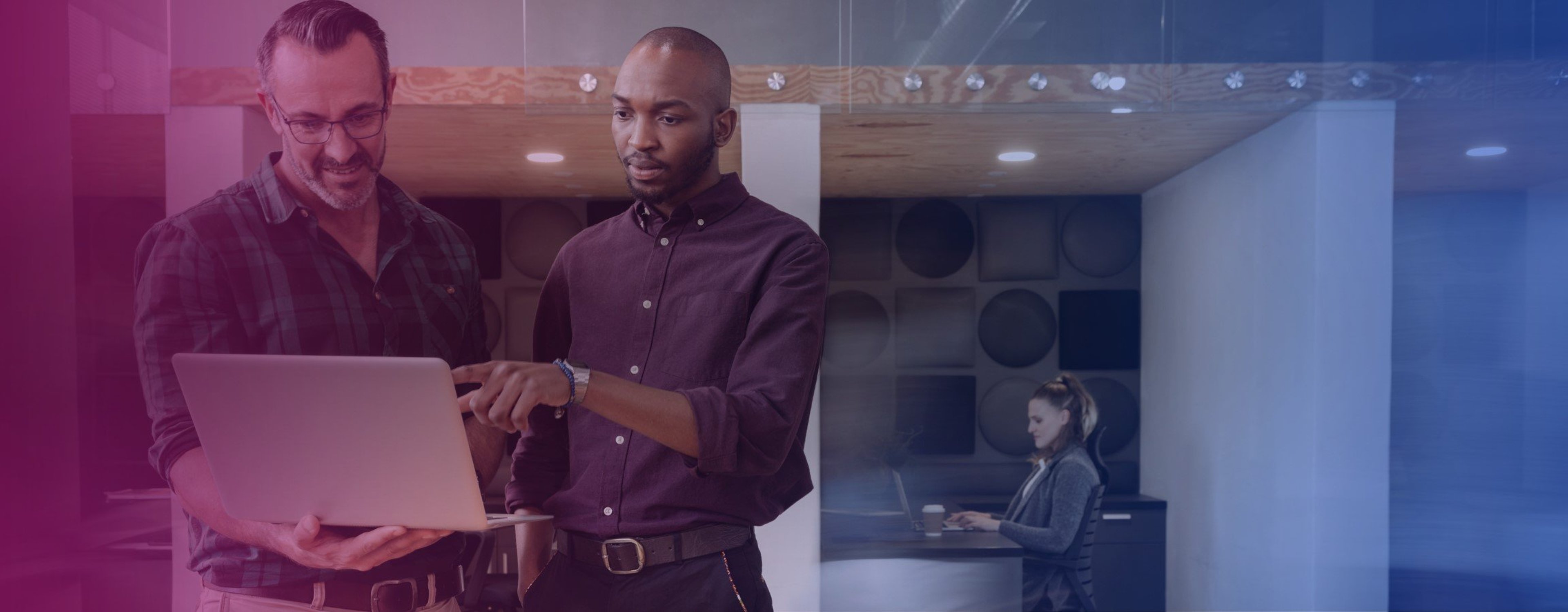Two employees staring at a piece of work together