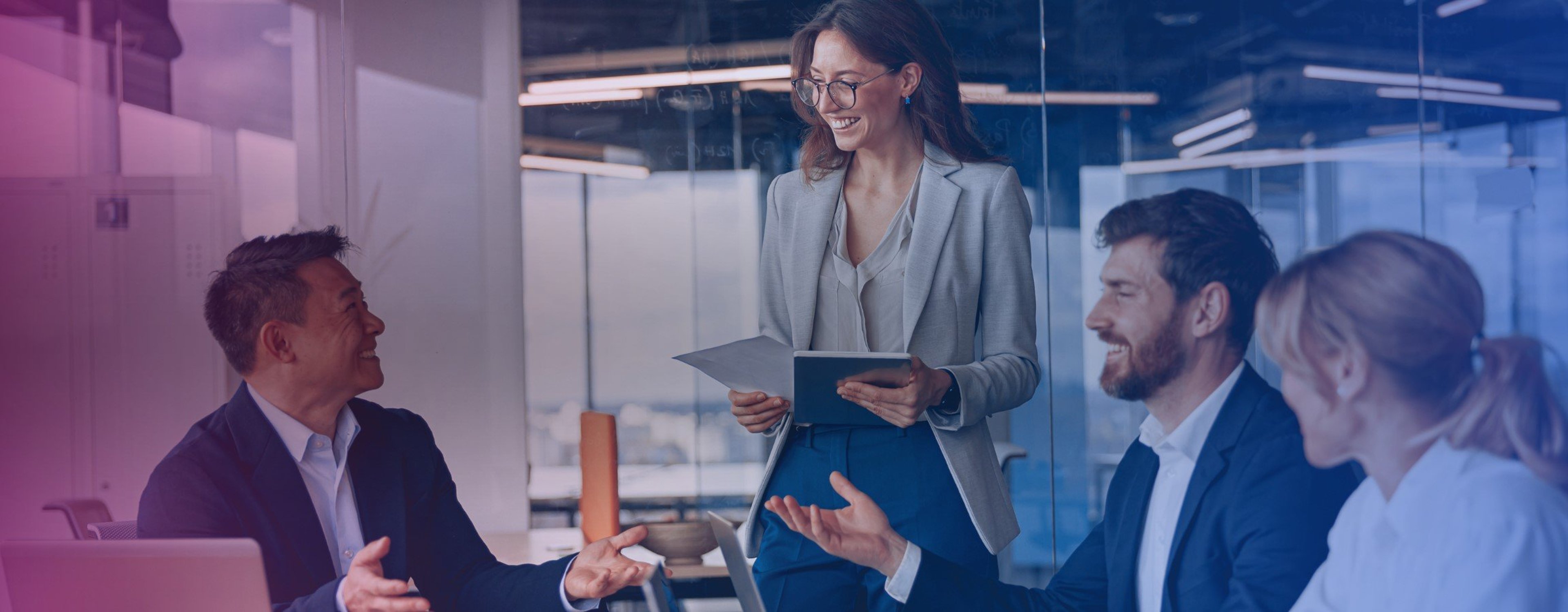 A stock image of employees conversing in an office