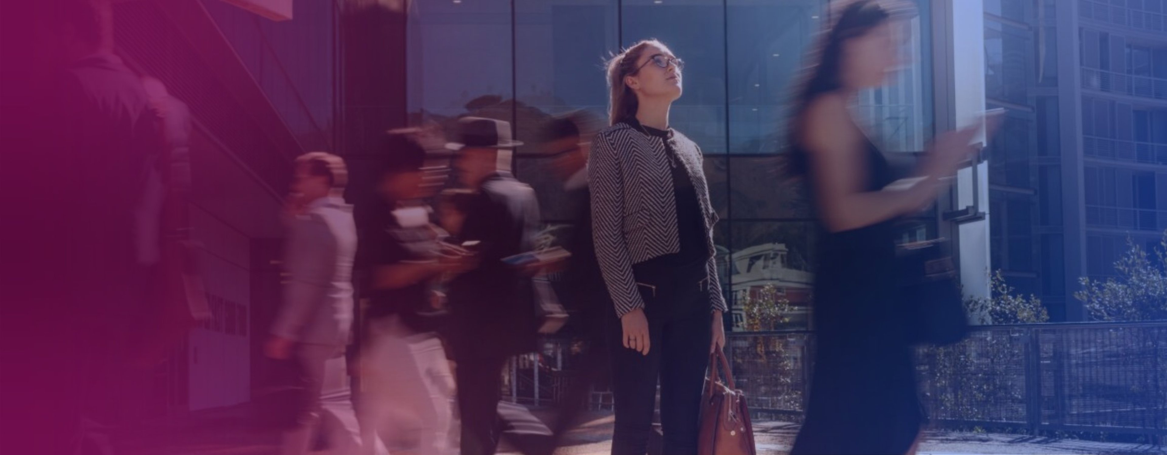 Stock image of employees leaving an office building