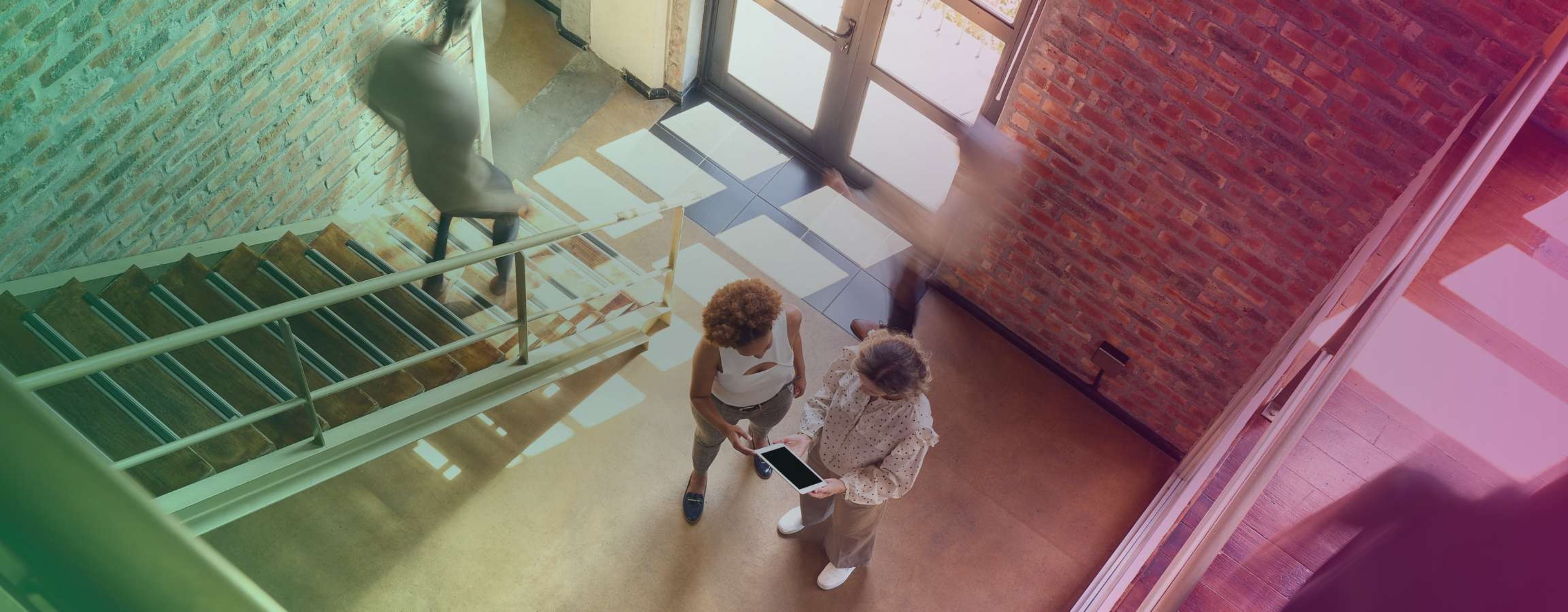 Two people talking on stairs
