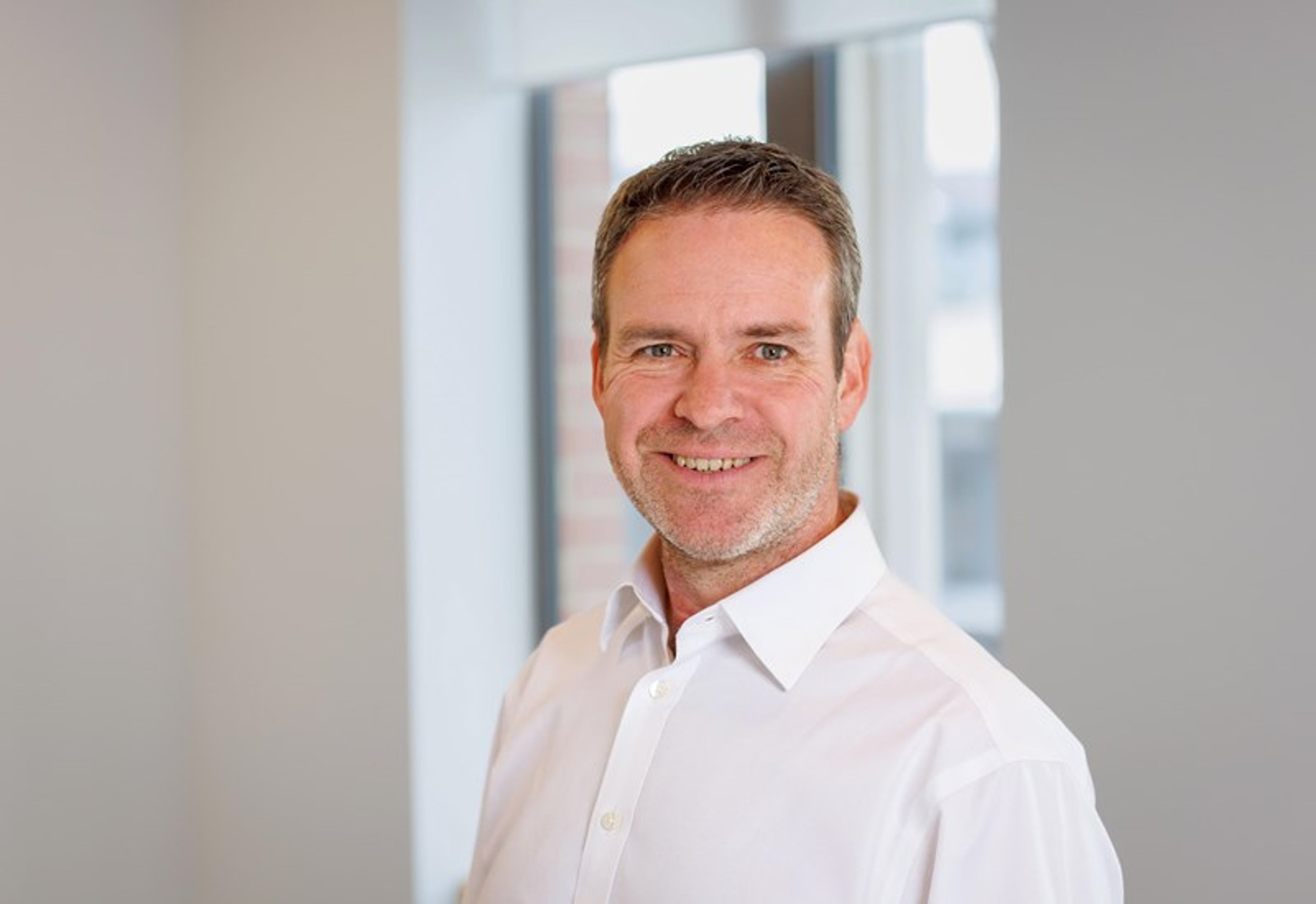 A headshot of Iain Sanderson